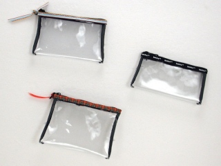 Stitched Clear Bags: We offer a range of strong stitched packaging in tried and tested designs such as drawstring bags, toiletry bags and cylindrical bags. Stitched in soft clear plastic with trim to match your house colors. We can also make purses and pencil cases to match.